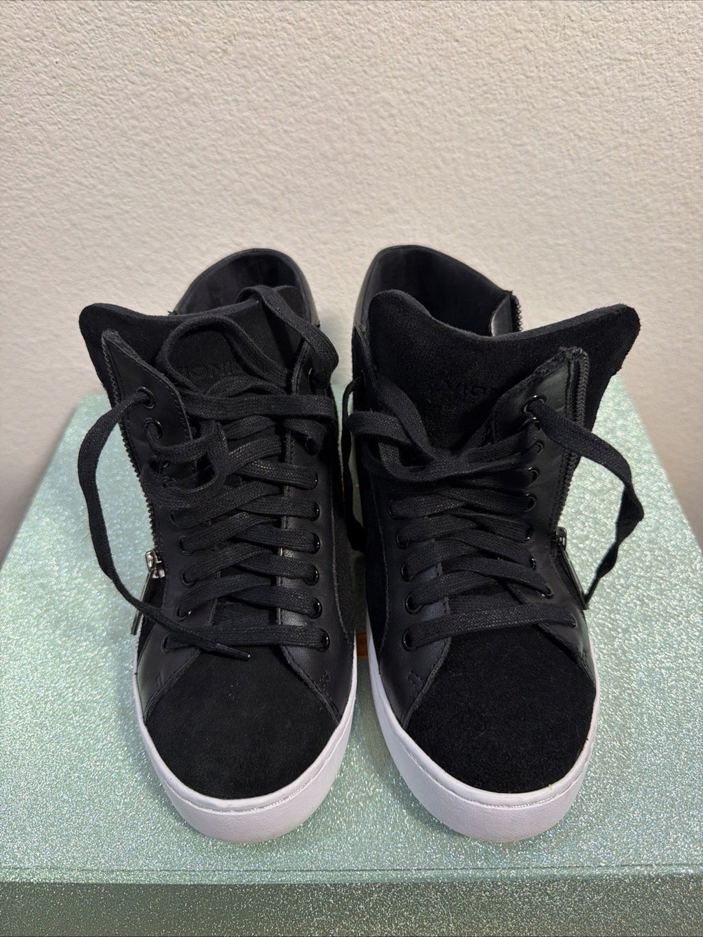 black hightop sneakers from Vionic featuring a side zipper and lace-up design.0