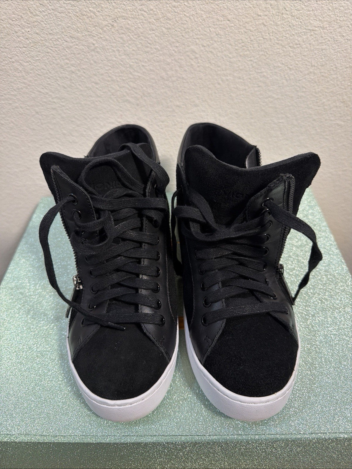 black hightop sneakers from Vionic featuring a side zipper and lace-up design.0
