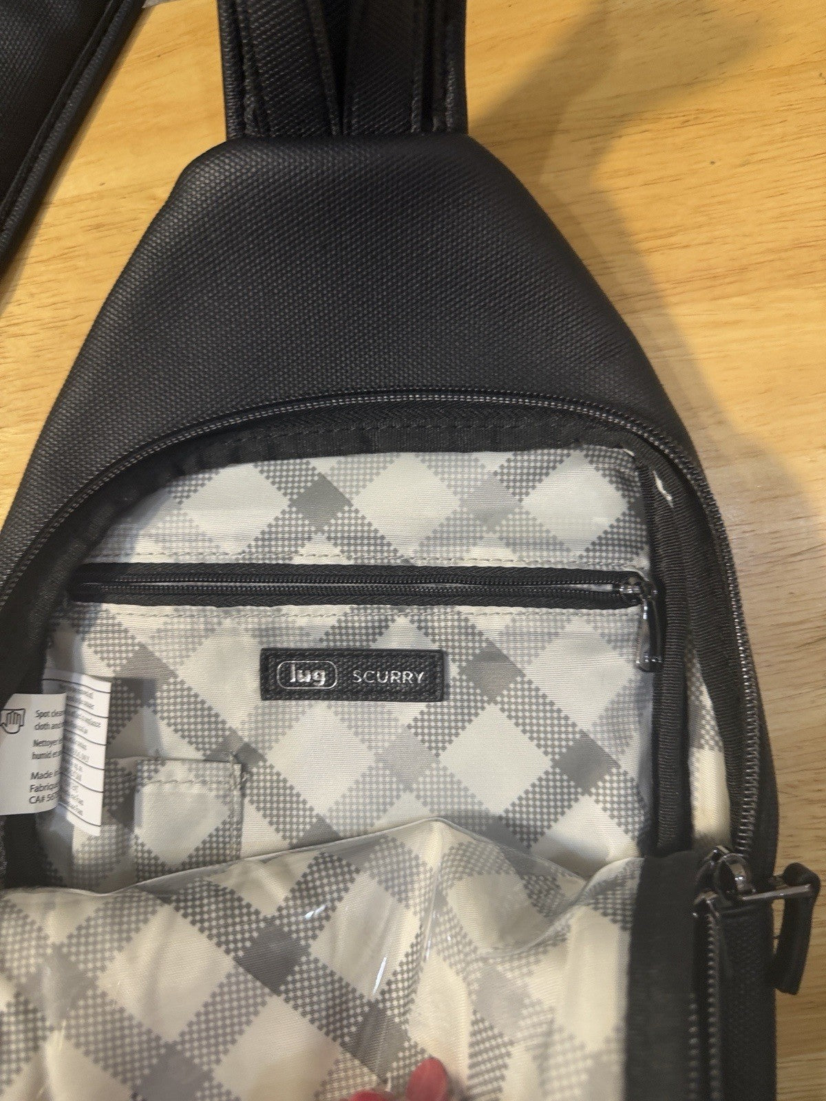 Compact Lug Sling Bag with Quilted Front Panel. Multiple Zip Pockets Black1