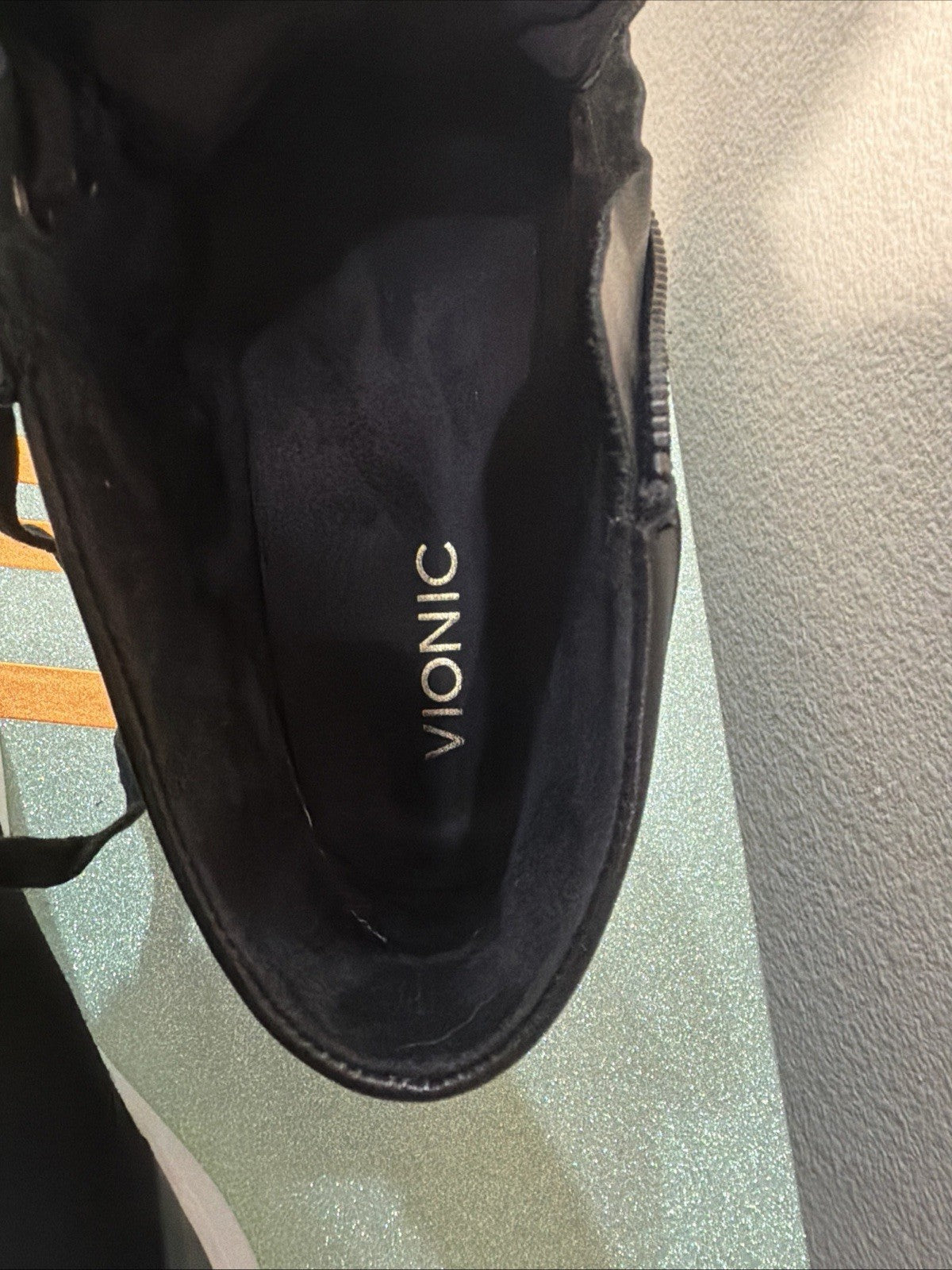 black hightop sneakers from Vionic featuring a side zipper and lace-up design.4
