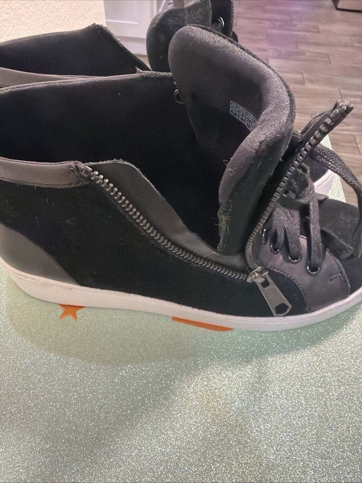 black hightop sneakers from Vionic featuring a side zipper and lace-up design.2